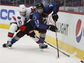 Senators winger Tom Pyatt tries to poke the puck away fromAvalanche winger J.T. Compher in the third period of Saturday's game at Denver.