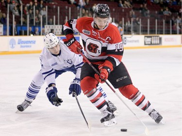 Travis Barron and Michael McLeod battle for the puck in the first period as the Ottawa 67's take on the Mississauga Steelheads in game 4 in Ontario Hockey League playoff action at TD Place Arena.