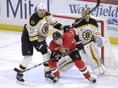 Boston Bruins' Zdeno Chara (33) checks Ottawa Senators' Mark Stone (61) as goaltender Tuuka Rask (40) looks on during second period NHL hockey action in Ottawa, Monday March 6, 2017.