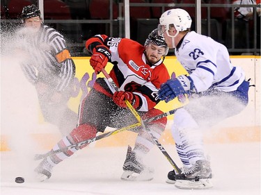 Tye Felhaber pulls up as Stefan LeBlanc comes in to defend in the first period as the Ottawa 67's take on the Mississauga Steelheads in Game 4 in Ontario Hockey League playoff action at TD Place Arena.