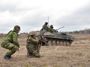 A Canadian soldier is shown in this photo helping train a Ukrainian soldier in March 2017. DND photo.