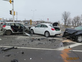 Firefighter extrication experts removed the rear door and centre post on the vehicle at left to free a passenger trapped in the front seat in this three-vehicle crash.