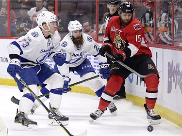 Ottawa Senators' Zack Smith (15) vies for the puck with Tampa Bay Lightning's Adam Erne (73) and Luke Witkowski (28) during first period NHL hockey action in Ottawa, Tuesday, March 14, 2017.