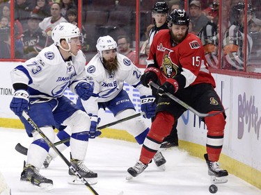 Ottawa Senators' Zack Smith (15) vies for the puck with Tampa Bay Lightning's Adam Erne (73) and Luke Witkowski (28) during first period NHL hockey action in Ottawa, Tuesday, March 14, 2017.