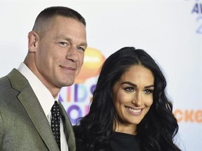 FILE - In this Saturday, March 11, 2017, file photo, John Cena, left, and Nikki Bella arrive at the Kids&#039; Choice Awards at the Galen Center in Los Angeles. Cena and Bella finished off their opponents at WrestleMania and then decided to take on what could be their biggest challenge yet: Marriage. Cena got down on one knee after the pair defeated The Miz and Marse in a tag team match Sunday, April 2, at WrestleMania 33. (Photo by Jordan Strauss/Invision/AP, File)