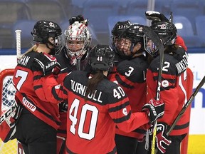 Canada&#039;s goaltender Shannon Szabados (1) is congratulated by teammates after they defeated Russia in IIHF Ice Hockey Women&#039;s World Championship preliminary round action in Plymouth, Mich., on Monday, April 3, 2017. THE CANADIAN PRESS/Jason Kryk
