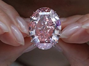 FILE - In this Wednesday, March 29, 2017, file photo, the &ampquot;Pink Star&ampquot; diamond, the most valuable cut diamond ever offered at auction, is displayed by a model at a Sotheby&#039;s auction room in Hong Kong. The stunning 59.6 carat diamond has sold for HK$553 million or US$71.2 million at a Sotheby&#039;s auction in Hong Kong, setting a record for any diamond or jewel. It&#039;s Also the highest price for any work ever sold at auction in Asia. (AP Photo/Vincent Yu, File)