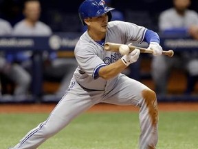 Toronto Blue Jays' Darwin Barney drops down a squeeze bunt on a pitch from Tampa Bay Rays' Blake Snell during the seventh inning of a baseball game Thursday, April 6, 2017, in St. Petersburg, Fla. Blue Jays Russell Martin scored.