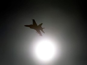 In this Feb. 28, 2017, photo, Thomas &ampquot;Tom&ampquot; P. McGee of the VX-9 Vampire squadron from Naval Air Weapons Station China Lake, flies an F/A-18E Super Hornet toward the sun over Death Valley National Park, Calif. Military jets roaring over national parks have long drawn complaints from hikers and campers. But in California&#039;s Death Valley, the low-flying combat aircraft skillfully zipping between the craggy landscape has become a popular attraction in the 3.3 million acre park in the Mojave Desert, 2