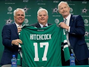 Dallas Stars newly hired NHL hockey team head coach Ken Hitchcock, center, poses for photos with team general manager Jim Nill, right, and president Jim Lites during a news conference in Dallas, Thursday, April 13, 2017. Hitchcock is returning to coach the Stars where he won the Stanley Cup in 1999. He has since coached the Philadelphia Flyers, Columbus Blue Jackets and St. Louis Blues. (AP Photo/LM Otero)