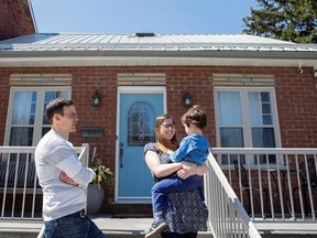 Sarah Blakely, husband Curtis and their son are pictured outside their three-bedroom home, in Toronto on Friday, April 14, 2017. They recently sold the house for more than $1 million and now expect to live mortgage-free in a four-bedroom purchase in their hometown of Ottawa. THE CANADIAN PRESS/Chris Young