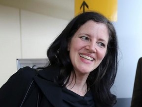 FILE - In this April 11, 2014 file photo, filmmaker Laura Poitras smiles after arriving at John F. Kennedy International Airport in New York. Poitras‚Äô travel nightmare began a decade ago when the award-winning documentary filmmaker started getting detained at airports every time she tried to step foot back in the United States. She would be stopped without explanation more than 50 times on foreign trips and dozens of times during domestic travel. Only now is Poitras beginning to unravel the my