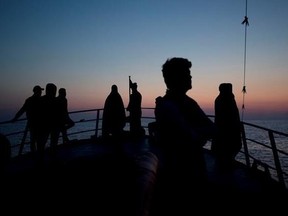 In this April 7, 2017, migrants aboard of Golfo Azurro look towards Sicily a day after being rescued by members of Proactiva Open Arms NGO. (AP Photo/Bernat Armangue)