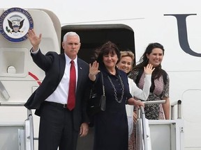 U.S. Vice President Mike Pence waves with his wife Karen Pence and his two daughters Charlotte and Audrey, right, before they leave for Japan, at Osan Air Base in Pyeongtaek, South Korea, Tuesday, April 18, 2017. (AP Photo/Lee Jin-man)