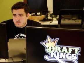 FILE- In this Sept. 9, 2015, file photo Len Don Diego, marketing manager for content at DraftKings, a daily fantasy sports company, works at his station at the company&#039;s offices in Boston. The daily fantasy sports industry has contracted starkly since questions about the legality of online games offered by companies sparked court and legislative battles across the U.S. last year. (AP Photo/Stephan Savoia, File)