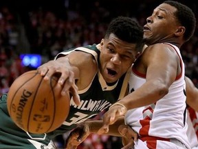 oronto Raptors guard Kyle Lowry (7) defends as Milwaukee Bucks forward Giannis Antetokounmpo (34) tries to move the ball up during second half NBA playoff basketball action in Toronto on Tuesday, April 18, 2017.