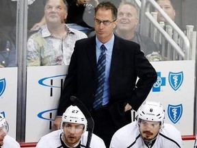 In this Thursday, Oct. 30, 2014, file photo, Los Angeles Kings assistant coach John Stevens stands behind his bench during the first period of an NHL hockey game against the Pittsburgh Penguins in Pittsburgh.