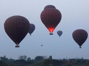 In this Tuesday, March 14, 2017 photo, hot air balloons are seen just after takeoff to fly over the ancient Myanmar city of Bagan. Balloon flights are a popular tourist activity in the city, which is home to the largest concentration of Buddhist temples, stupas and monuments in the world.(AP Photo/Esther Htusan)