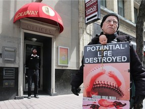 A protester stands outside the Morgentaler Clinic at 65 Bank Street in Ottawa Thursday April 20, 2017.