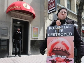 A protester stands outside the Morgentaler Clinic at 65 Bank Street in Ottawa Thursday April 20, 2017.