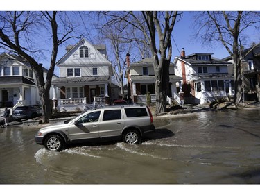 A vehicle drives along Belmont Avenue.