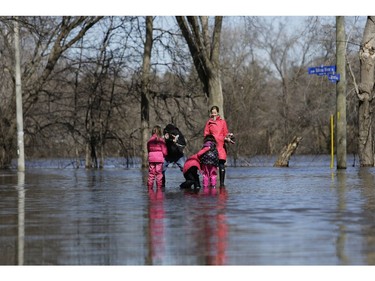 A family takes pictures on the flooded Belmont Avenue.