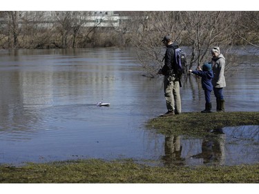 A family plays with a remote controlled boat in Brighton Beach Park.