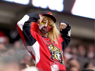 A Sens fan flexes his muscles in the second period.