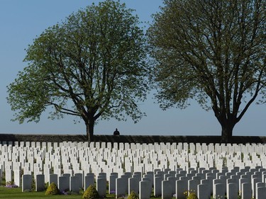 A French police officer stands guard at a Cabaret-Rouge cemetery near Vimy Ridge before a visit by Canadian Prime Minister Justin Trudeau and French President Francois Hollande, Sunday, April 9, 2017 near Arras, France.