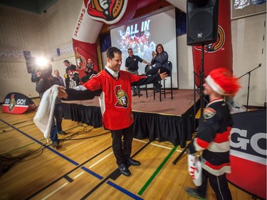 A. Lorne Cassidy Elementary School Grade 3 student Cole Mullens gets a hug from the principal after winning tickets to the first playoff game of the year during a rally with former players Chris Phillips and Shaun Van Allen.