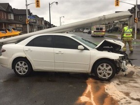 A picture posted by the Ottawa Paramedic Service's Twitter account shows the badly damaged front end of the white Mazda involved in a crash at the intersection of Greenbank Road and Dundonald Road on Wednesday, April 19, 2017.