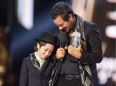 Adam Cohen with his son Cassius after accepting the JUNO for Leonard Cohen at the Juno Awards held on Sunday at the Canadian Tire Centre.