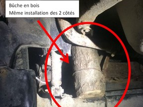 Police supplied this photo of this West Quebec driver who used logs to reinforce his car's broken suspension.