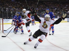 Derick Brassard, front, celebrates  a goal by Zack Smith, left, during the Senators' game against the Rangers at New York on Dec. 27.
