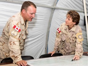 Brig.-Gen. Lise Bourgon confers with Sgt.-Maj. John Short as part of Joint Task Force Iraq in this file photo. Bourgon was honoured from her service at Rideau Hall Tuesday.