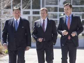 From left, Ontario Finance Minister Charles Sousa, Toronto Mayor John Tory, and federal Finance Minister Bill Morneau arrive for talks Tuesday in Toronto on the housing market in the Greater Toronto Area.