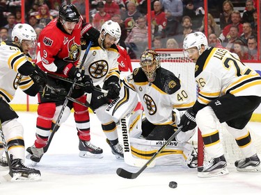 Bobby Ryan is kept away from the puck by Ryan Spooner, left, and Colin Miller while goalie Tuukka Rask and John-Michael Liles keep their eyes on the puck in the first period.