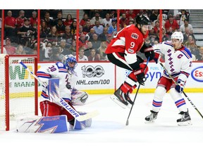 Bobby Ryan of the Ottawa Senators jumps out of the way of the puck as Henrik Lundqvist makes the save.