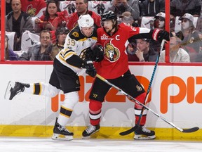 The Senators' Erik Karlsson battles for position against Matt Beleskey of the Bruins in the first period in Game 1 at the Canadian Tire Centre on Wednesday, April 12, 2017.