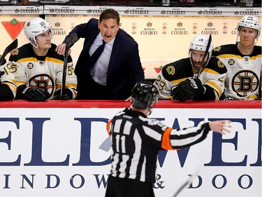 Boston coach argues a non-call with referee Kelly Sutherland in overtime.