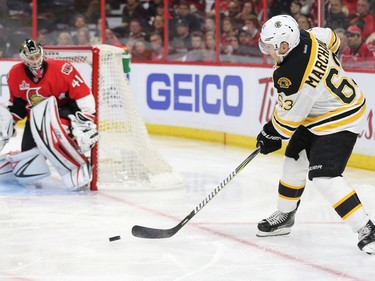 Brad Marchand passes in front of Craig Anderson in the second period.