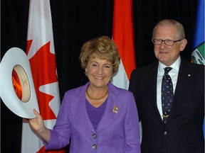 Princess Margriet of the Netherlands (L) and her husband Professor Pieter van Vollenhoven (R) receive white hats from the city of Calgary during a visit in 2010.