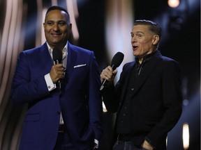 Hosts Russell Peters (L) on stage with Bryan Adams during the JUNO Awards at the Canadian Tire Centre in Ottawa, Ontario, on April 2, 2017.