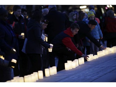 Candles are placed at the base of the National War Memorial.