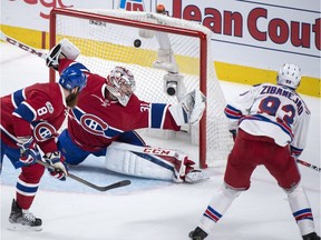 Mika Zibanejad, right, scores the overtime winner against Canadiens netminder Carey Price to give the Rangers a 3-2 victory in Montreal on Thursday night.