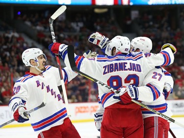 Chris Kreider, left, Mika Zibanejad and Ryan McDonagh of the New York Rangers celebrate McDonagh's goal against the Ottawa Senators.