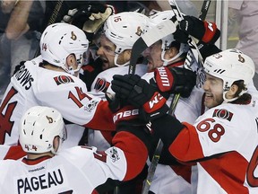 The Ottawa Senators including, Clarke MacArthur (16), Alex Burrows (14), Mike Hoffman (68) and Jean-Gabriel Pageau (44) celebrate after defeating the Boston Bruins 3-2 during overtime in game six of a first-round NHL hockey Stanley Cup playoff series, Sunday, April 23, 2017, in Boston.