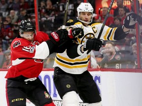Clarke MacArthur checks Zdeno Chara in the first period of Game 1 at the Canadian Tire Centre on Wednesday, April 12, 2017.