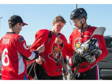 Clarke MacArthur (R) and Kyle Turris sign autographs for Dylan Sullivan as the Ottawa Senators practice at the Bell Sensplex in advance of their next NHL playoff game against the Boston Bruins on Saturday. The Bruins are up 1-0 in a best of seven series.