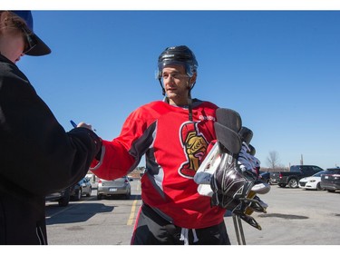 Clarke MacArthur signs an autograph outside in the sunshine as the Ottawa Senators practice at the Bell Sensplex in advance of their next NHL playoff game against the Boston Bruins on Saturday. The Bruins are up 1-0 in a best of seven series.